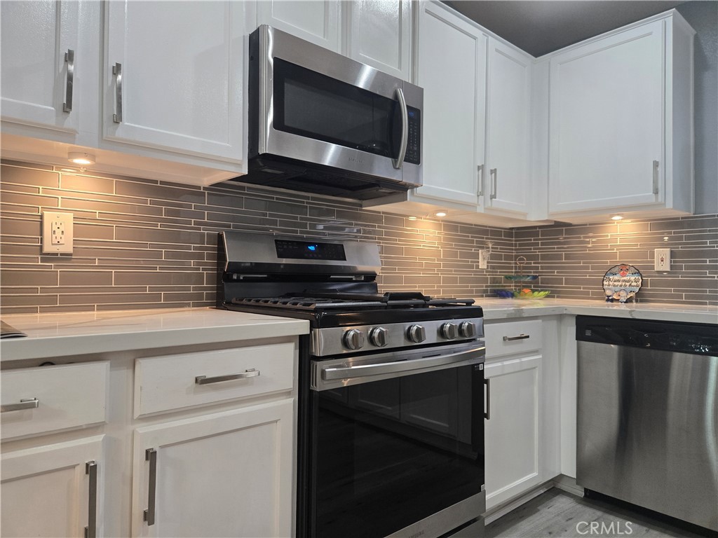 33860 Bell Thousand Palms, CA 92276 - Photo 42 of 49 a kitchen with cabinets stainless steel appliances and a sink