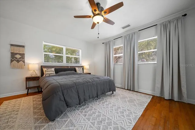 a bedroom with a large bed and a chandelier