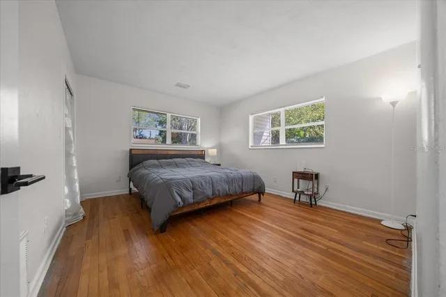 a bedroom with a bed a table and chair