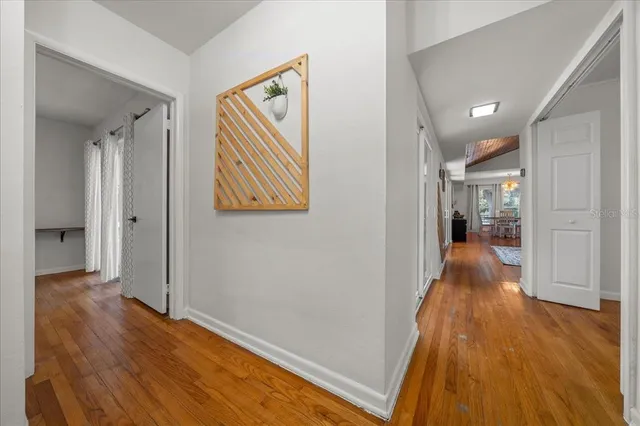 a view of hallway with wooden floor