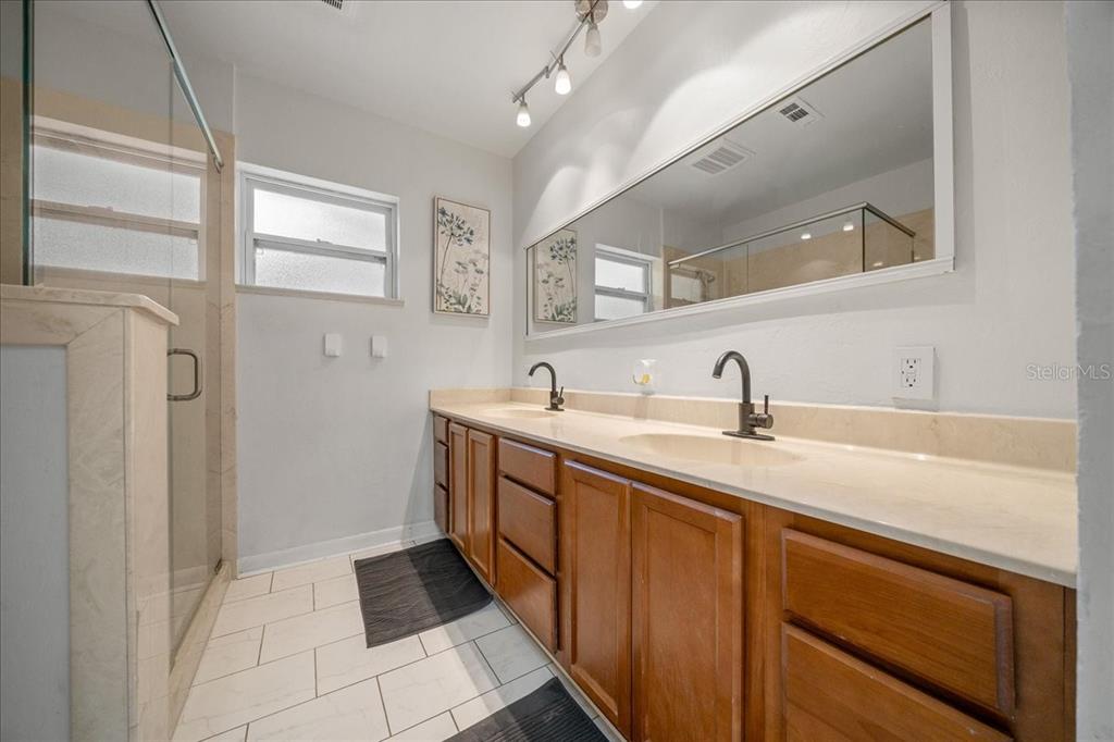 2475 Southwest 7th Avenue Ocala, FL 34471 - Photo 18 of 35 a spacious bathroom with a double vanity sink and mirror
