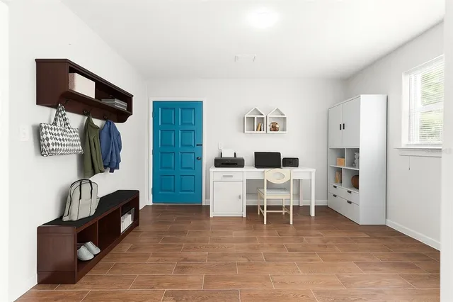 a living room with furniture a flat screen tv and a table