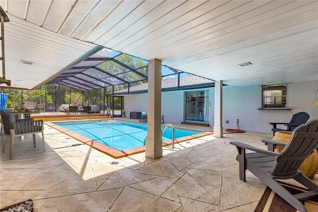 a view of a patio with a table and chairs under an umbrella