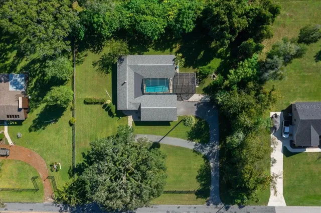an aerial view of a house with a yard