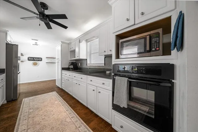 a kitchen with stainless steel appliances granite countertop a stove microwave and refrigerator