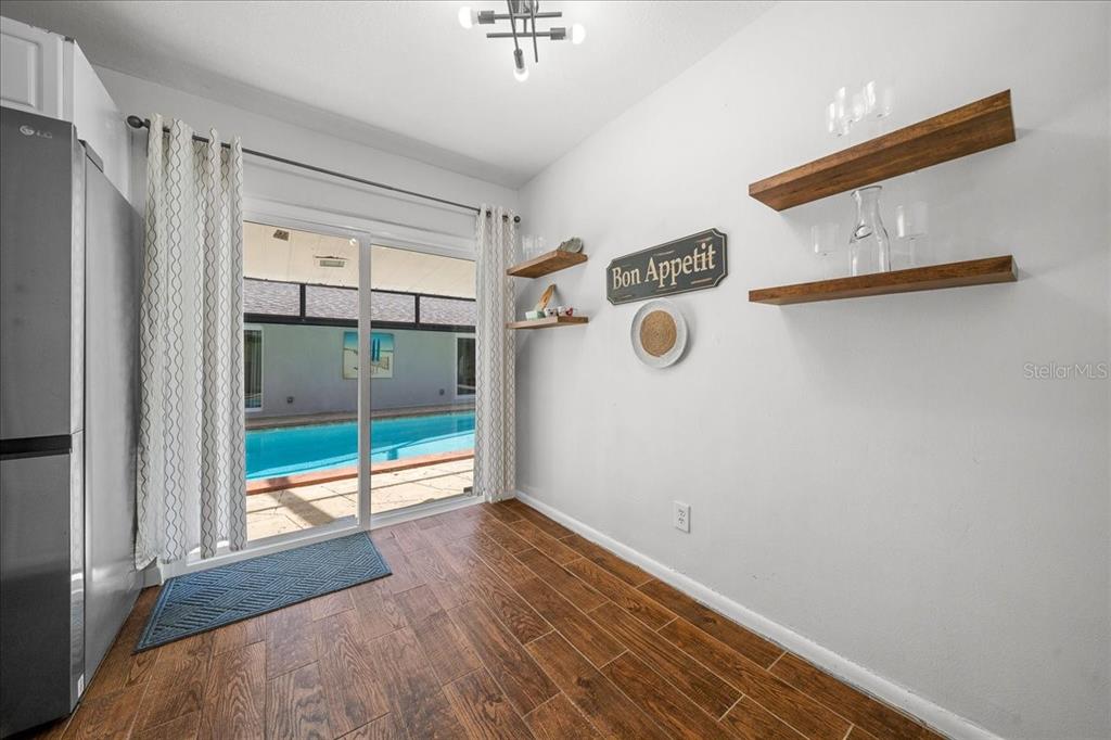 2475 Southwest 7th Avenue Ocala, FL 34471 - Photo 8 of 35 a view of an empty room with wooden floor and a window