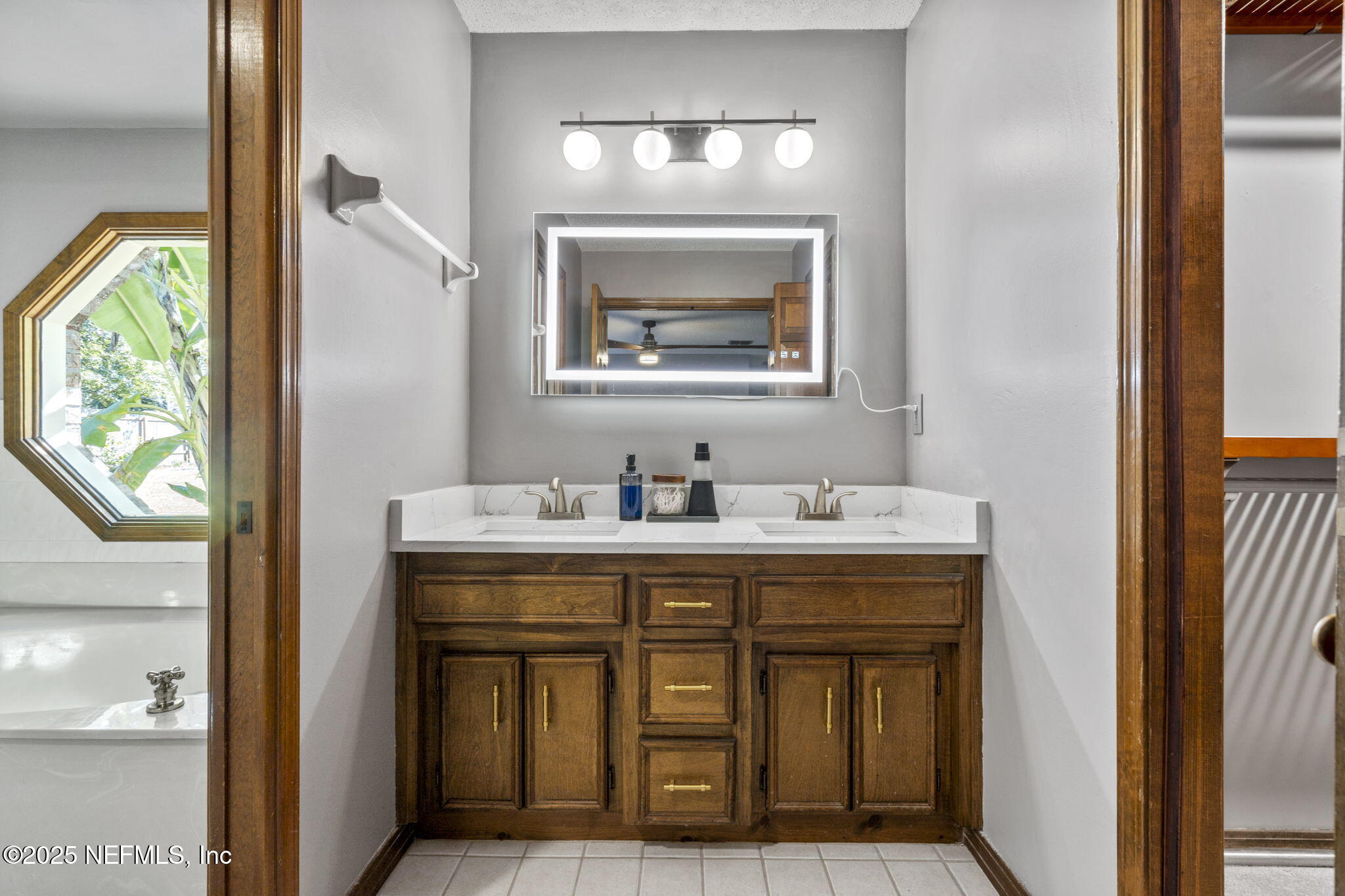 2587 Bayou Ridge Court Orange Park, FL 32065 - Photo 21 of 40 a bathroom with a sink and a mirror
