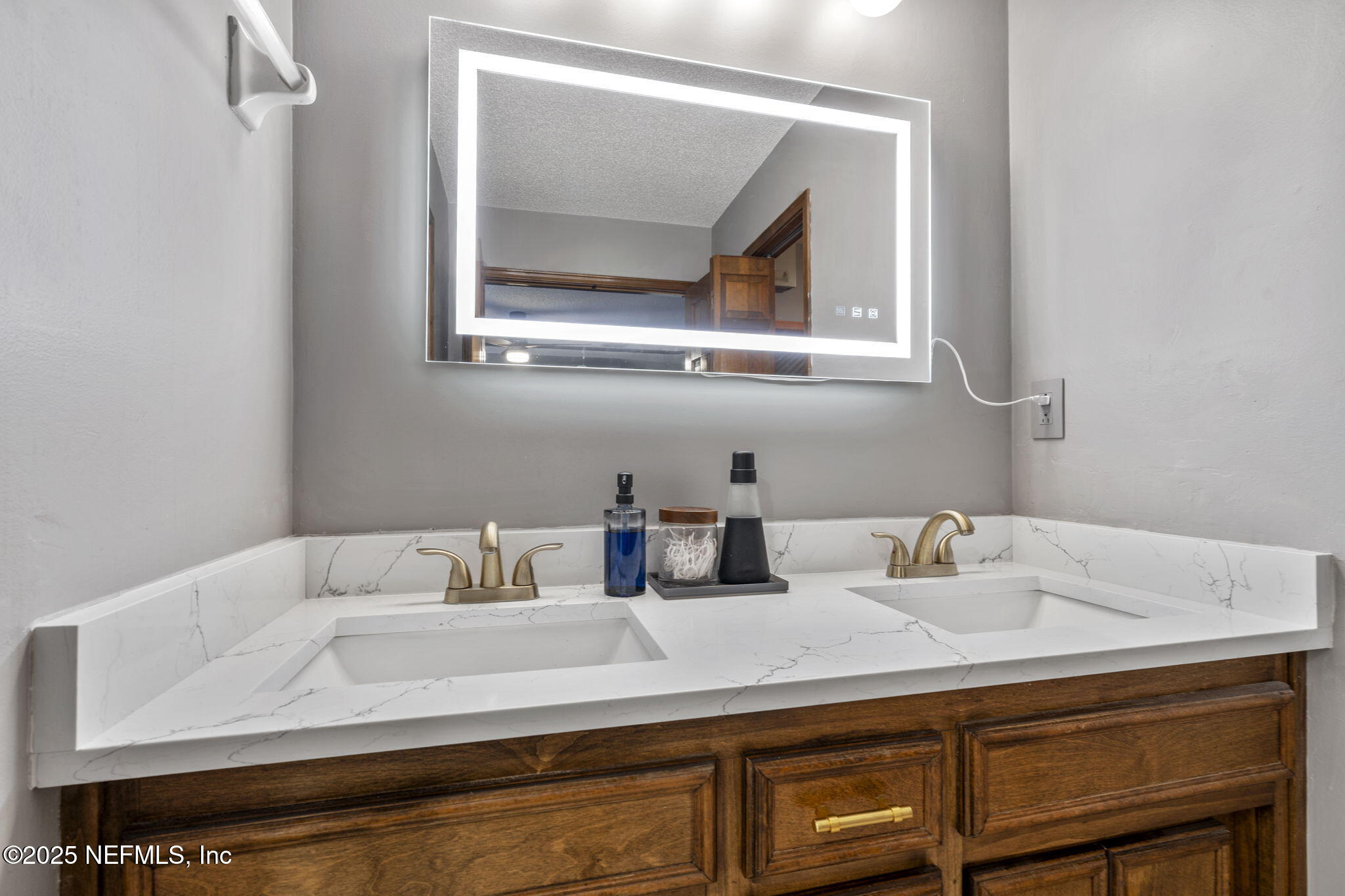 2587 Bayou Ridge Court Orange Park, FL 32065 - Photo 22 of 40 a bathroom with a sink and a mirror