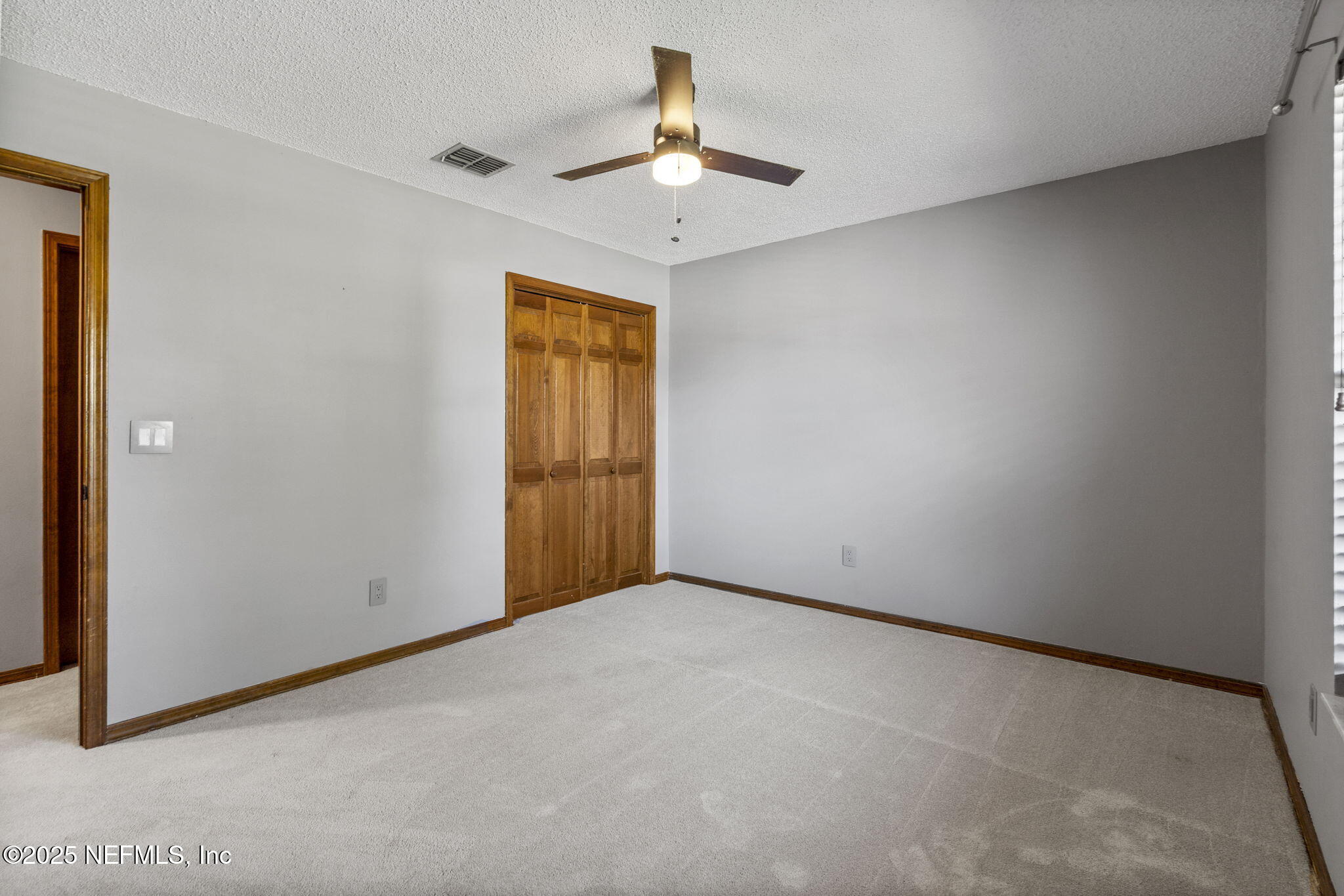 2587 Bayou Ridge Court Orange Park, FL 32065 - Photo 26 of 40 an empty room with a ceiling fan and a window