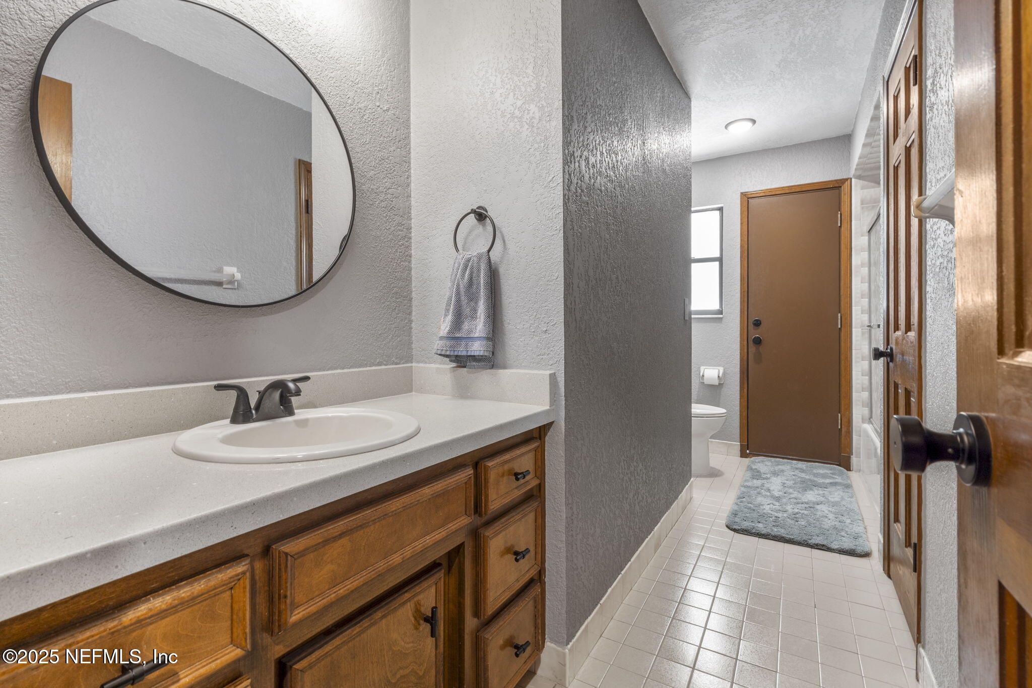 2587 Bayou Ridge Court Orange Park, FL 32065 - Photo 27 of 40 a en suite bathroom with a granite countertop sink and a mirror
