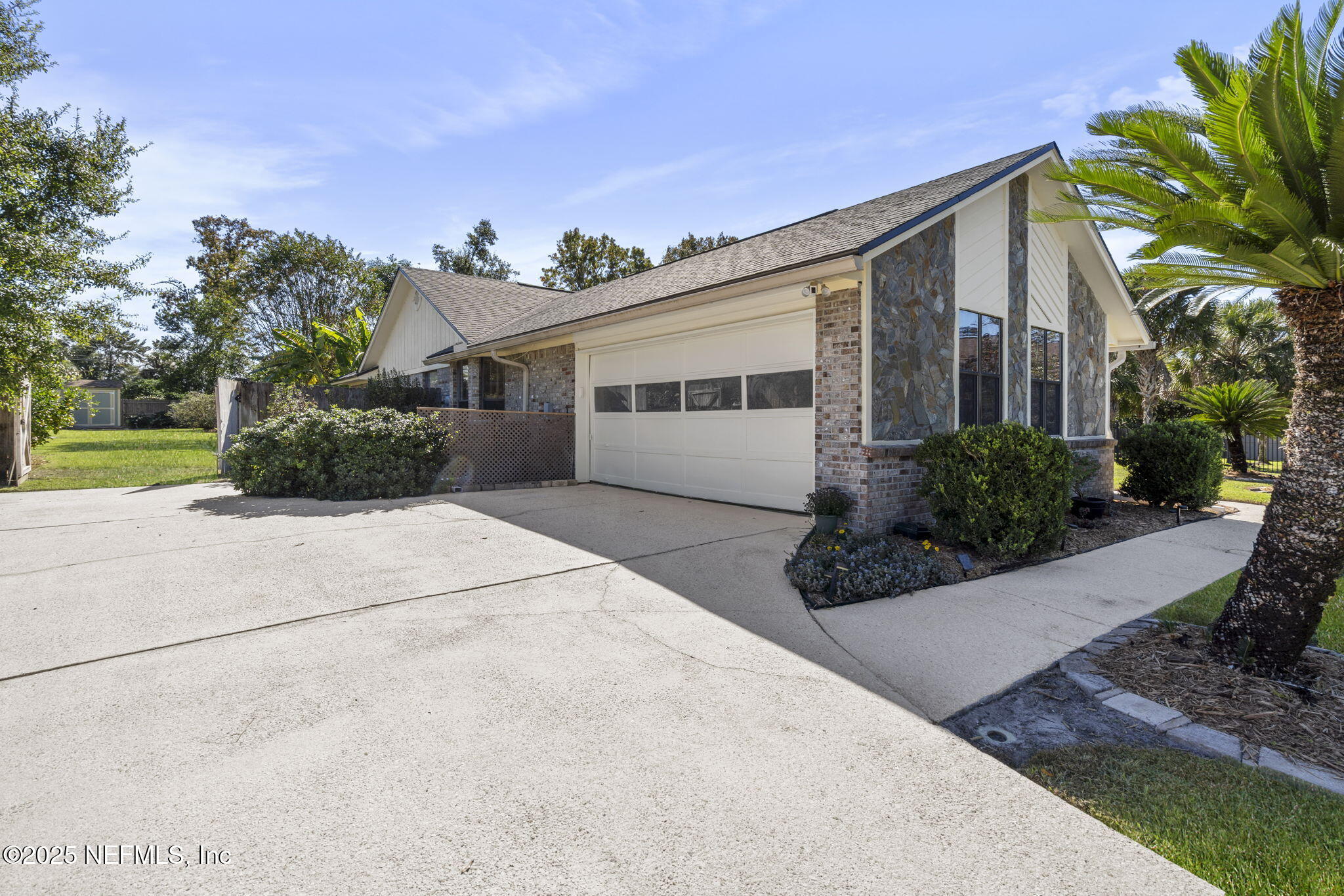 2587 Bayou Ridge Court Orange Park, FL 32065 - Photo 33 of 40 a front view of a house with a yard and potted plants