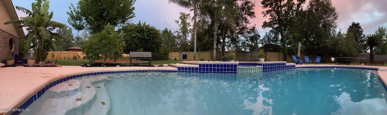 2587 Bayou Ridge Court Orange Park, FL 32065 - Photo 5 of 40 a swimming pool with outdoor seating and yard