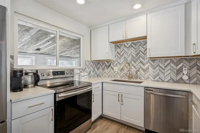 a kitchen with white cabinets and appliances