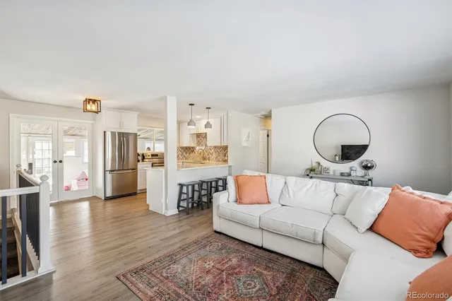 a living room with furniture and wooden floor