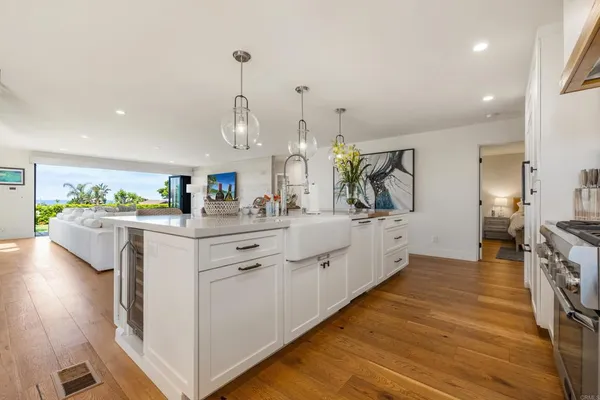 a kitchen with stainless steel appliances kitchen island granite countertop a stove a sink and a refrigerator