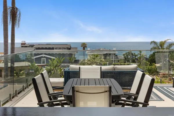 a view of roof deck with chair and wooden floor
