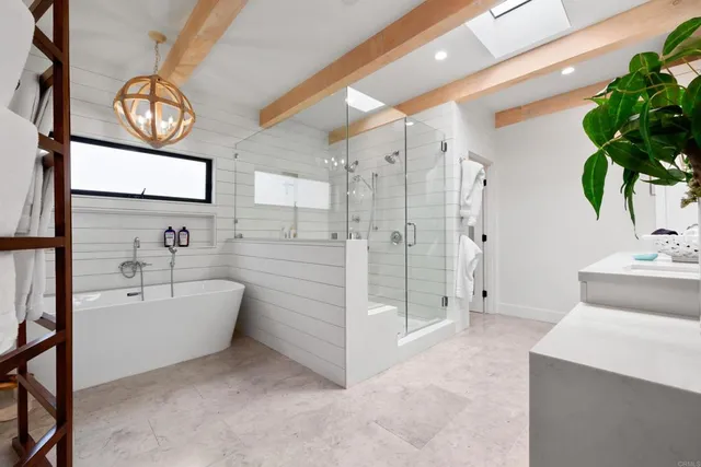 a bathroom with a tub sink and mirror
