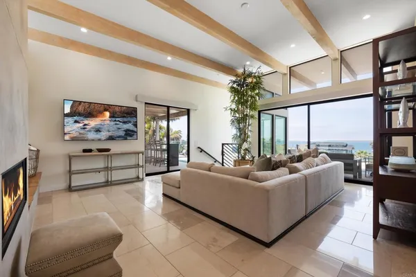 a living room with furniture a flat screen tv and a large window