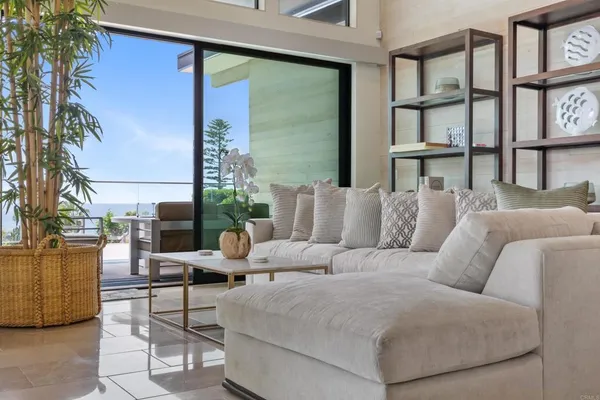 a balcony with furniture and a potted plant