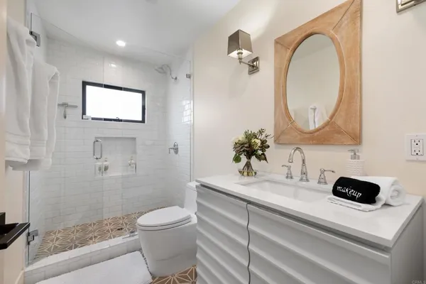 a bathroom with a toilet a sink and mirror