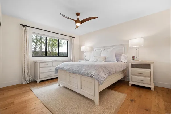 a bedroom with a bed and a ceiling fan