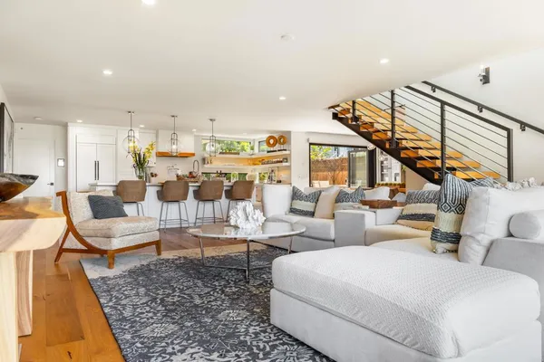 a living room with lots of furniture and a rug
