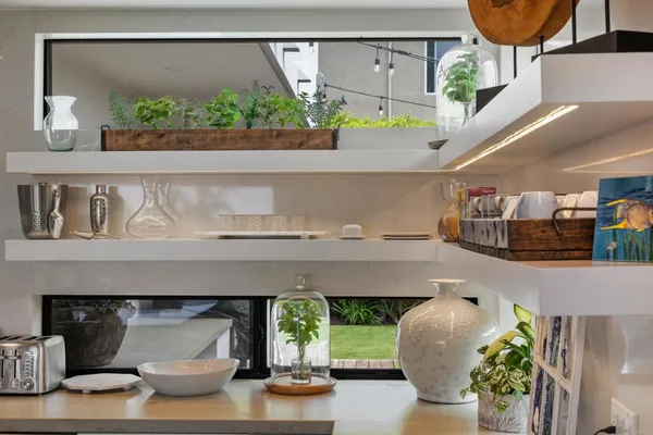 a living room with furniture and a potted plant