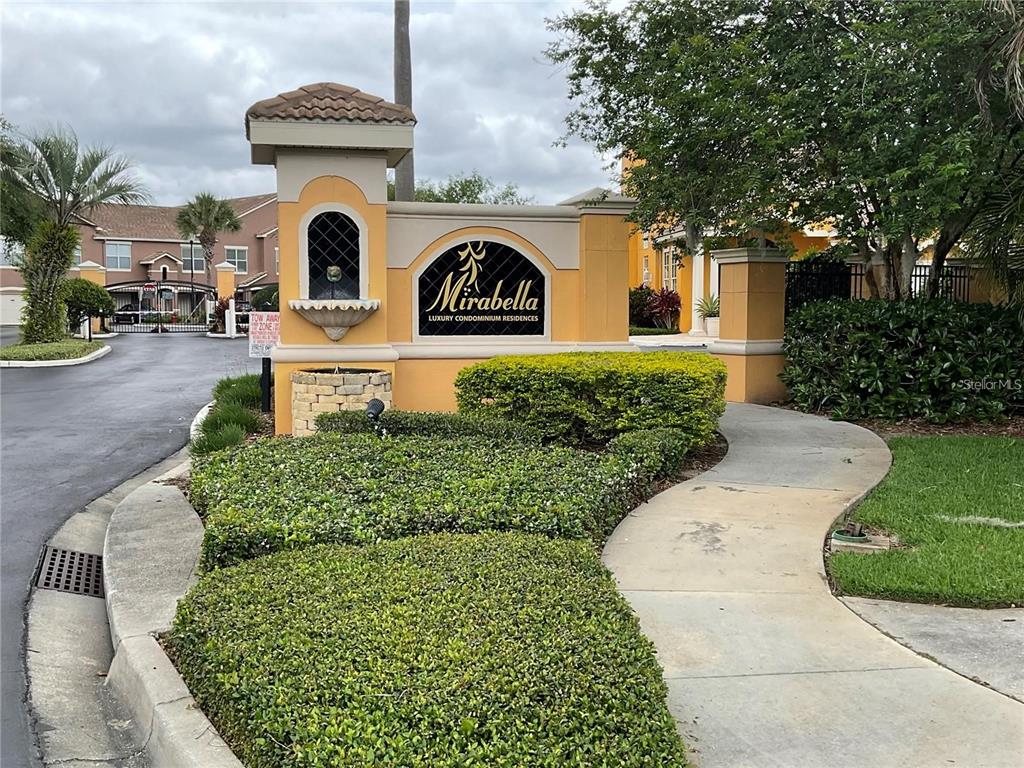 8813 Villa View Circle, Unit 104 Orlando, FL 32821 - Photo 2 of 14 a front view of a house with garden