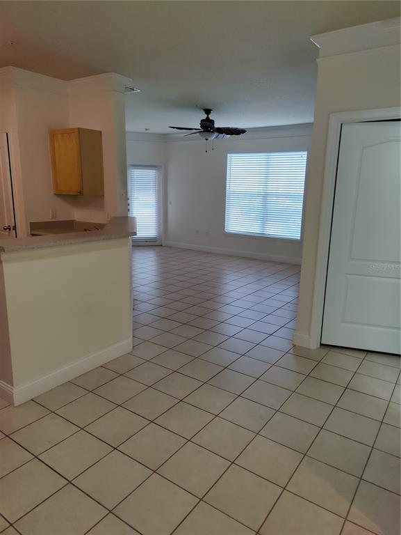 8813 Villa View Circle, Unit 104 Orlando, FL 32821 - Photo 7 of 14 an empty room with wooden floor and cabinet