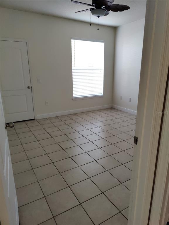 8813 Villa View Circle, Unit 104 Orlando, FL 32821 - Photo 9 of 14 a view of an empty room and window