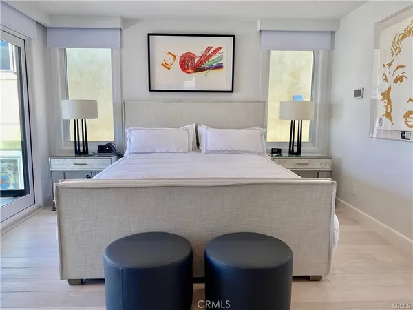 a bedroom with a bed and a painting on the wall