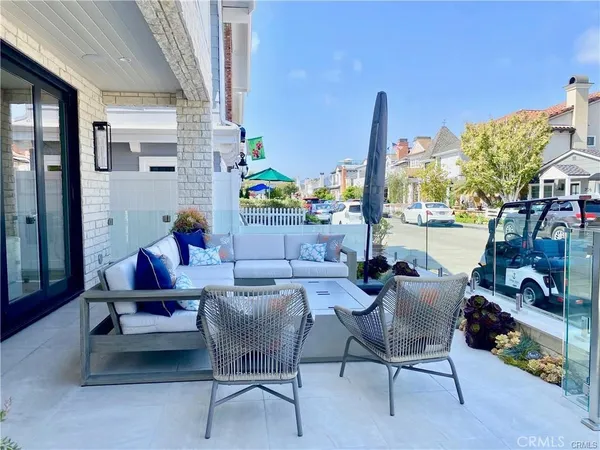 a dining room with furniture and a floor to ceiling window