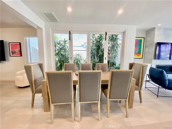 a dining room with furniture a rug and a large window