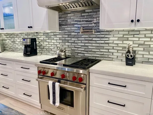 a kitchen with stove and cabinets