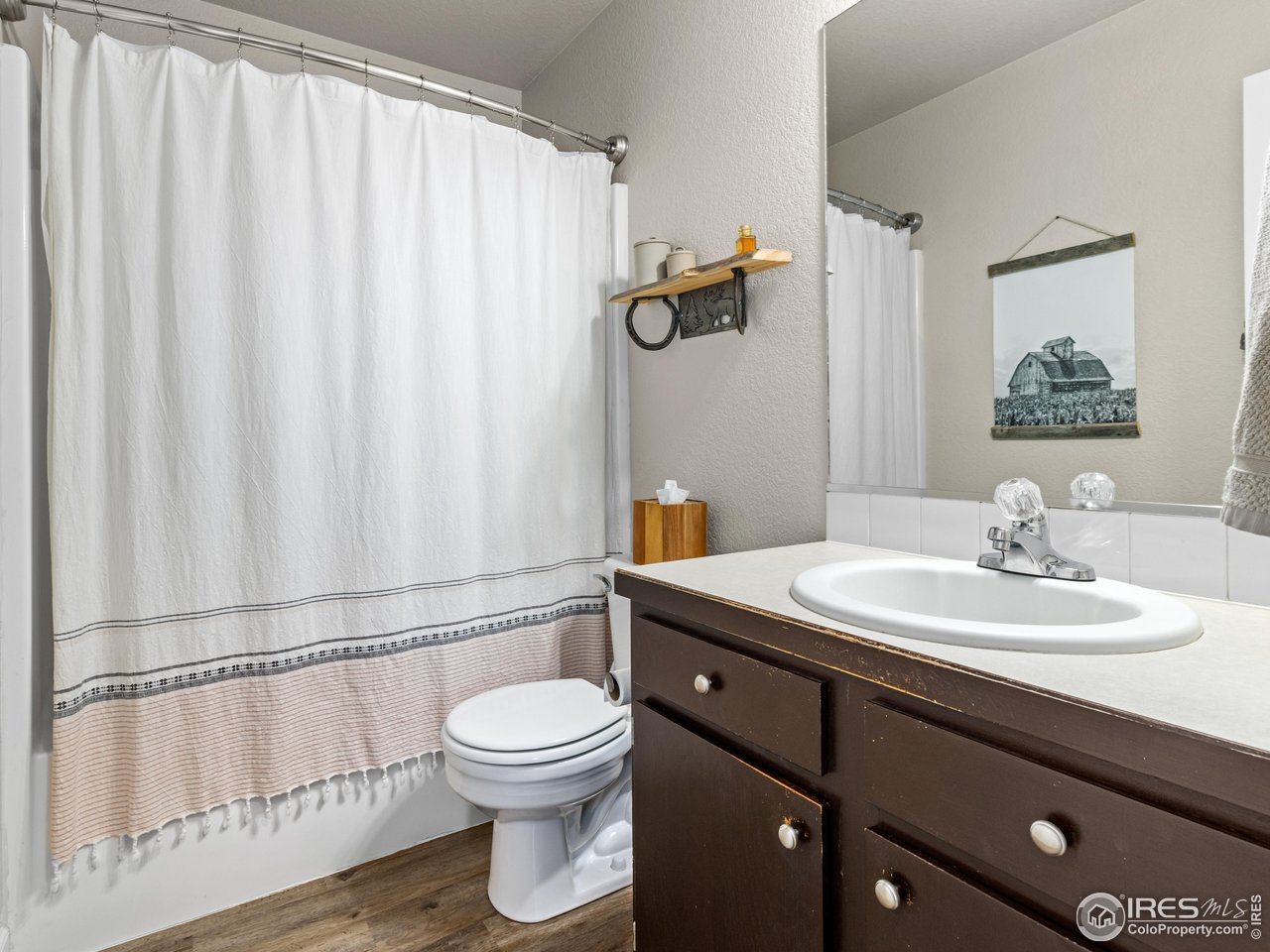 4610 Homestead Court Greeley, CO 80634 - Photo 12 of 18 a bathroom with a granite countertop sink and a mirror