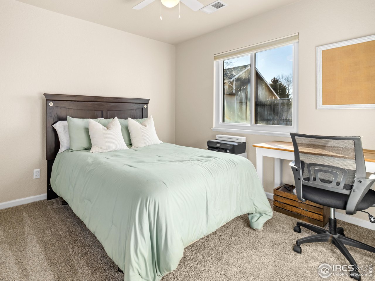 4610 Homestead Court Greeley, CO 80634 - Photo 13 of 18 a bedroom with a bed a desk and chair