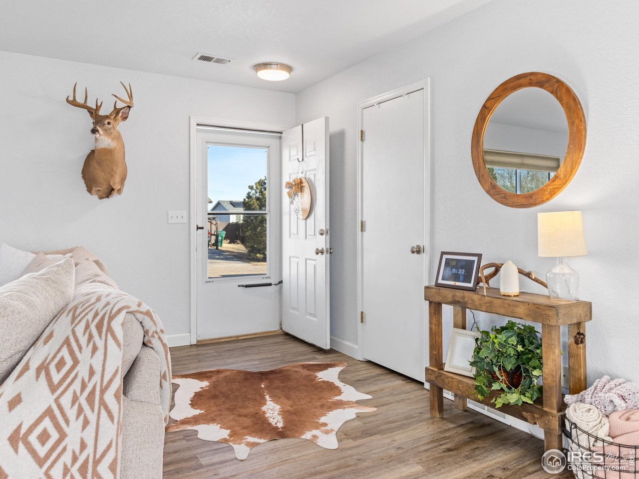 4610 Homestead Court Greeley, CO 80634 - Photo 3 of 18 a bedroom with a bed and a mirror