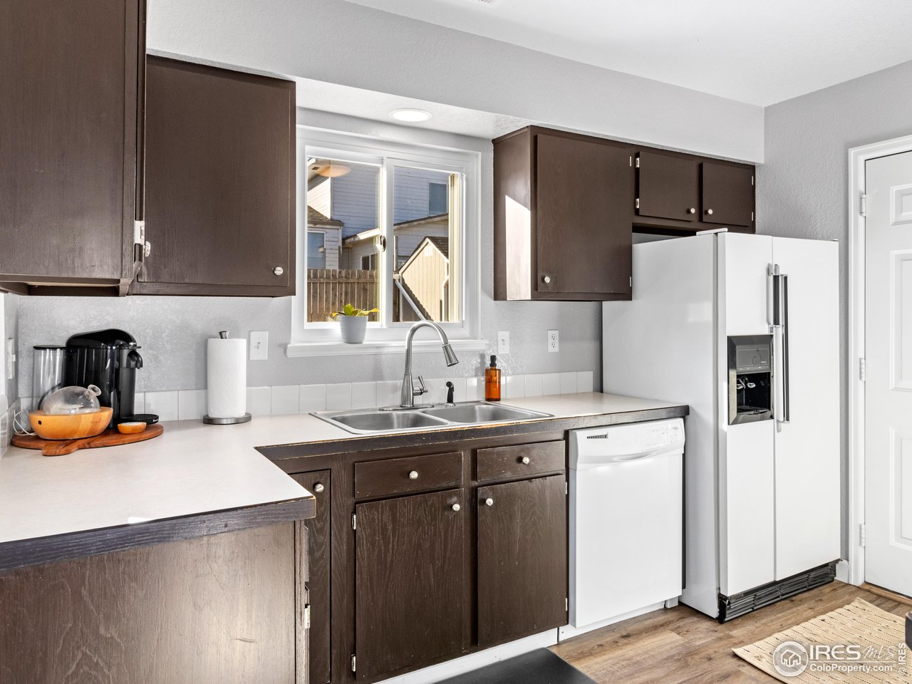 4610 Homestead Court Greeley, CO 80634 - Photo 4 of 18 a kitchen with a sink a stove and a refrigerator