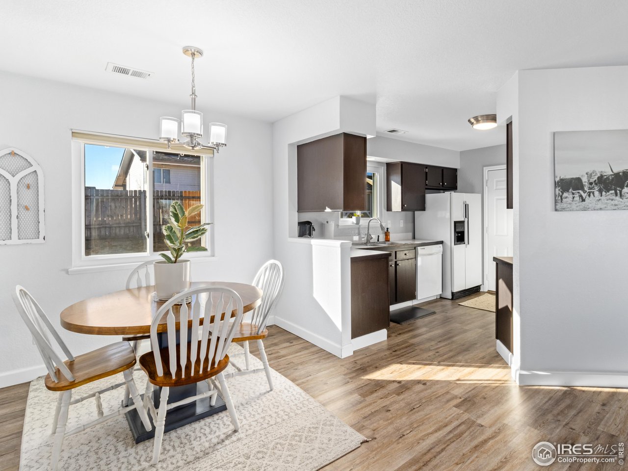 4610 Homestead Court Greeley, CO 80634 - Photo 8 of 18 a view of a dining room with furniture large window and wooden floor