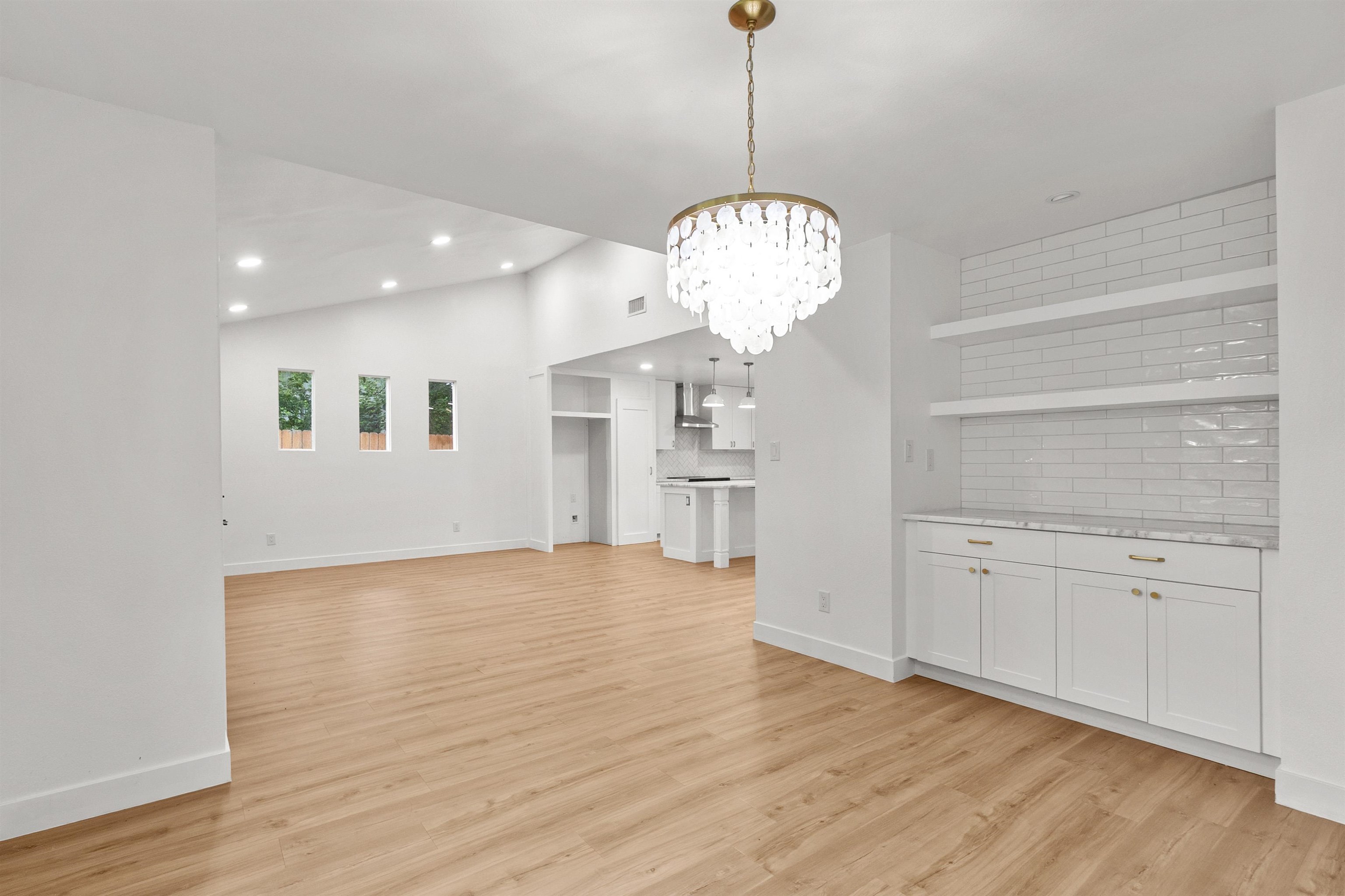 409 Ave R Marble Falls, TX 78654 - Photo 1 of 20 a view of a kitchen with wooden floor and a chandelier