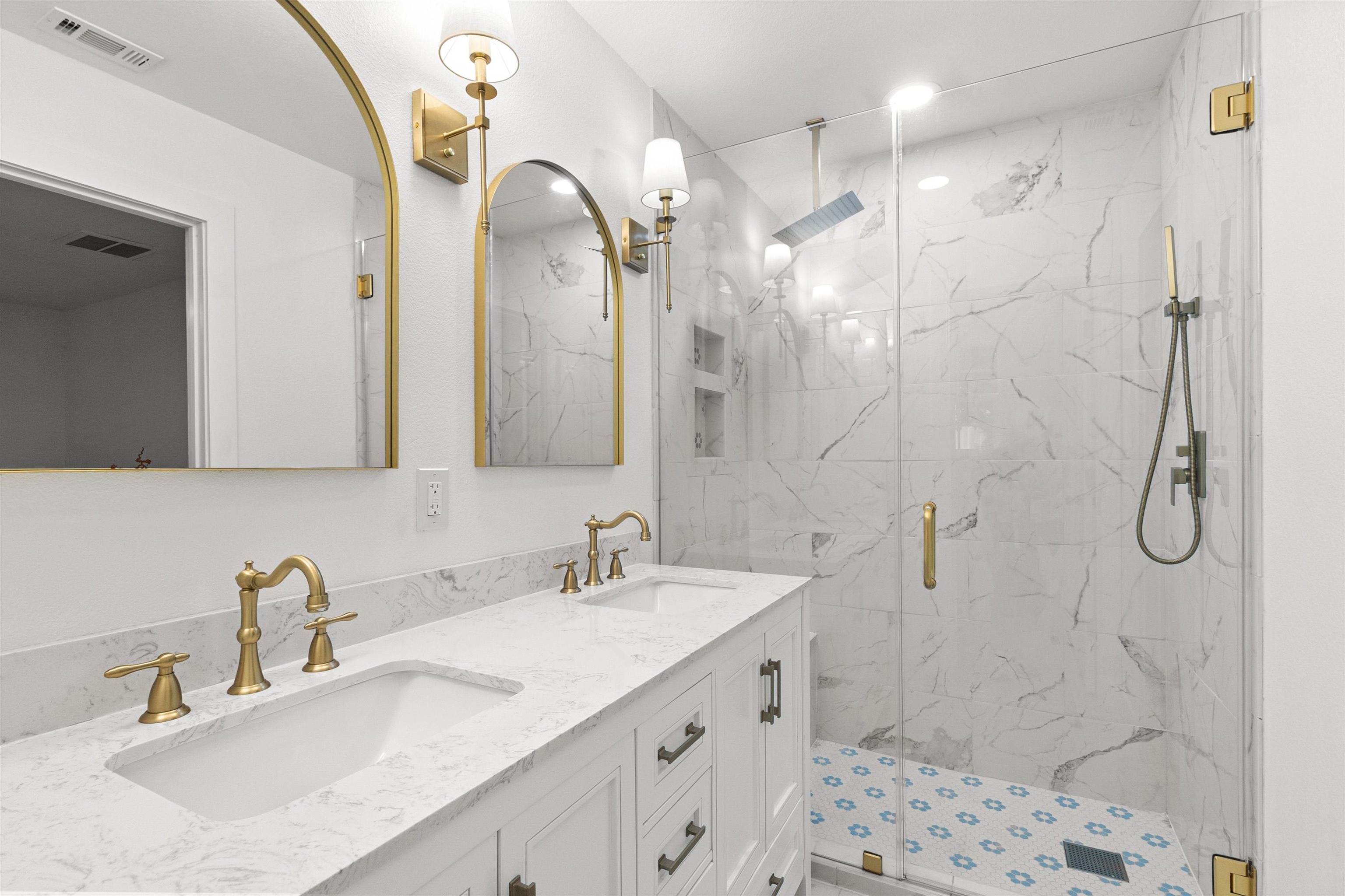 409 Ave R Marble Falls, TX 78654 - Photo 12 of 20 a bathroom with a double vanity sink mirror and shower