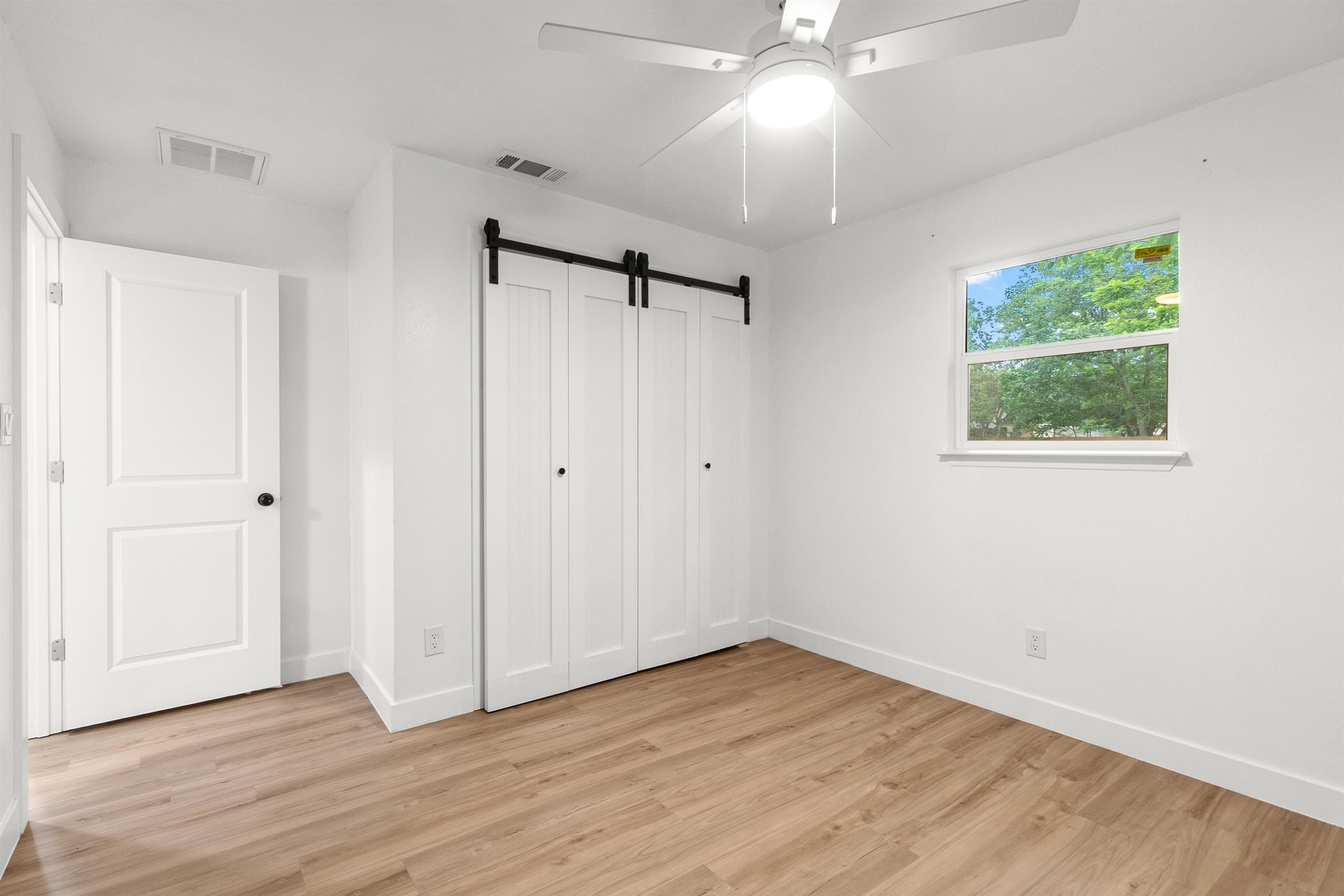 409 Ave R Marble Falls, TX 78654 - Photo 13 of 20 a view of an empty room with wooden floor and a window