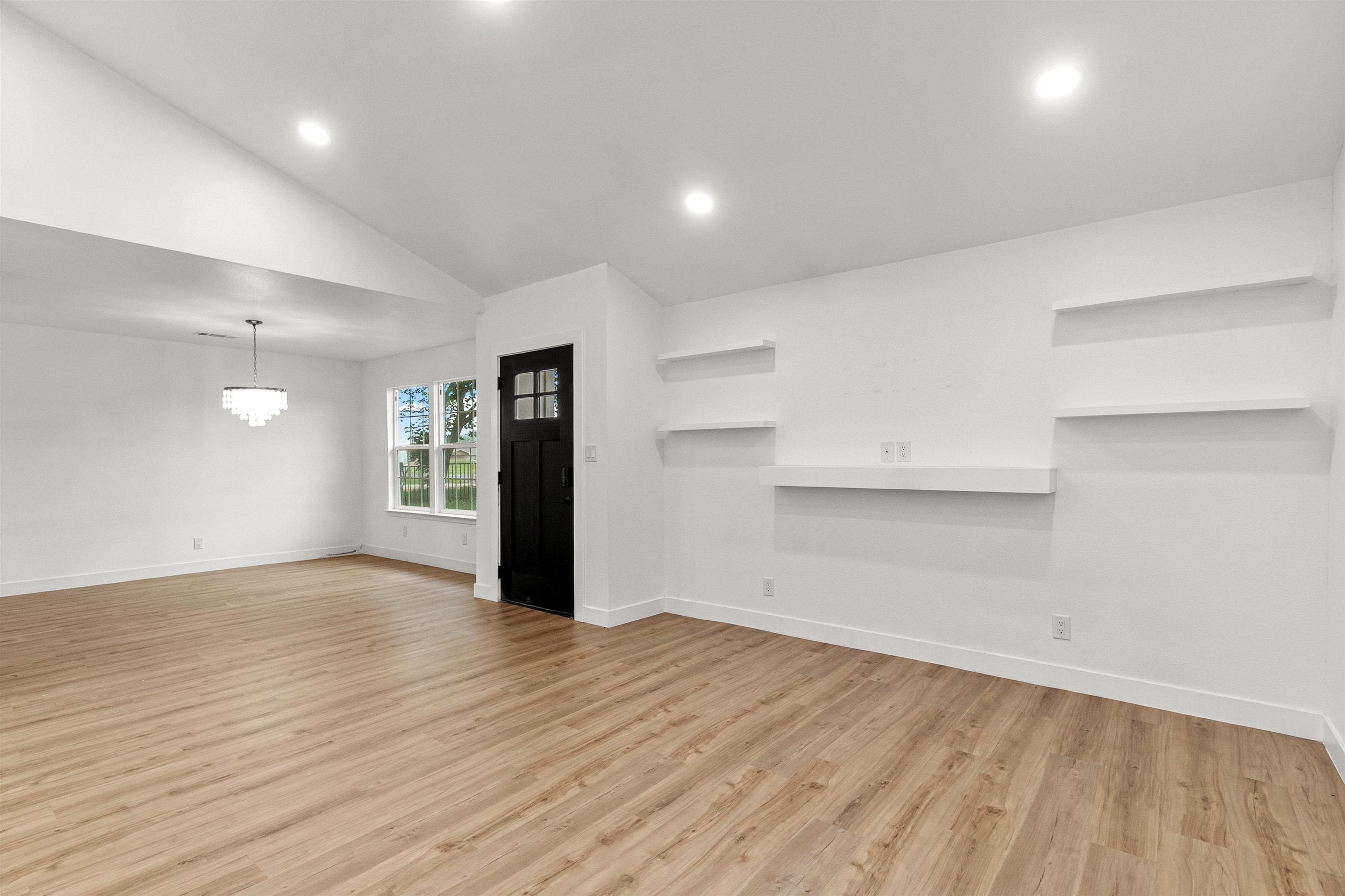 409 Ave R Marble Falls, TX 78654 - Photo 5 of 20 an empty room with wooden floor and windows