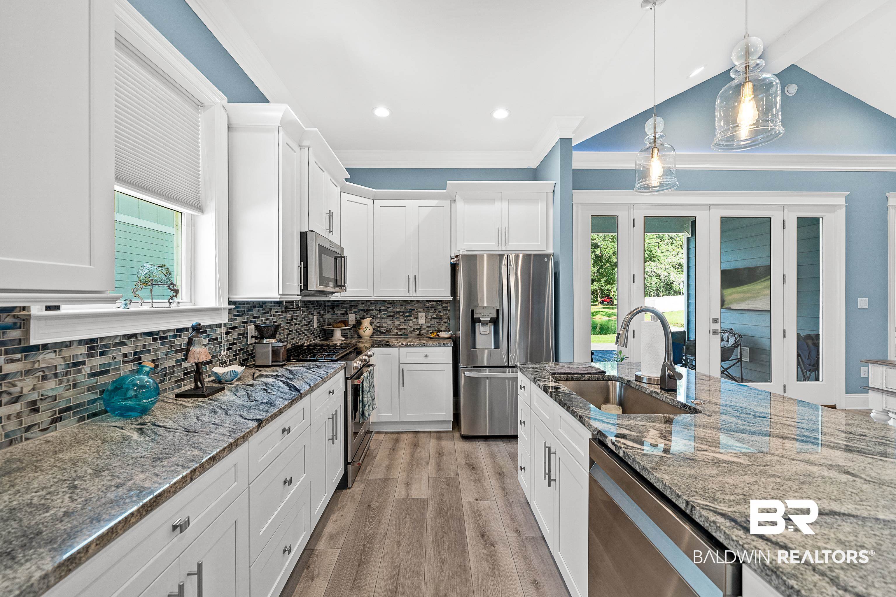 12329 Reunion Place, Unit LOT 38 Foley, AL 36535 - Photo 11 of 43 Kitchen featuring tasteful backsplash, stainless steel appliances, white cabinets, light stone countertops, and pendant lighting