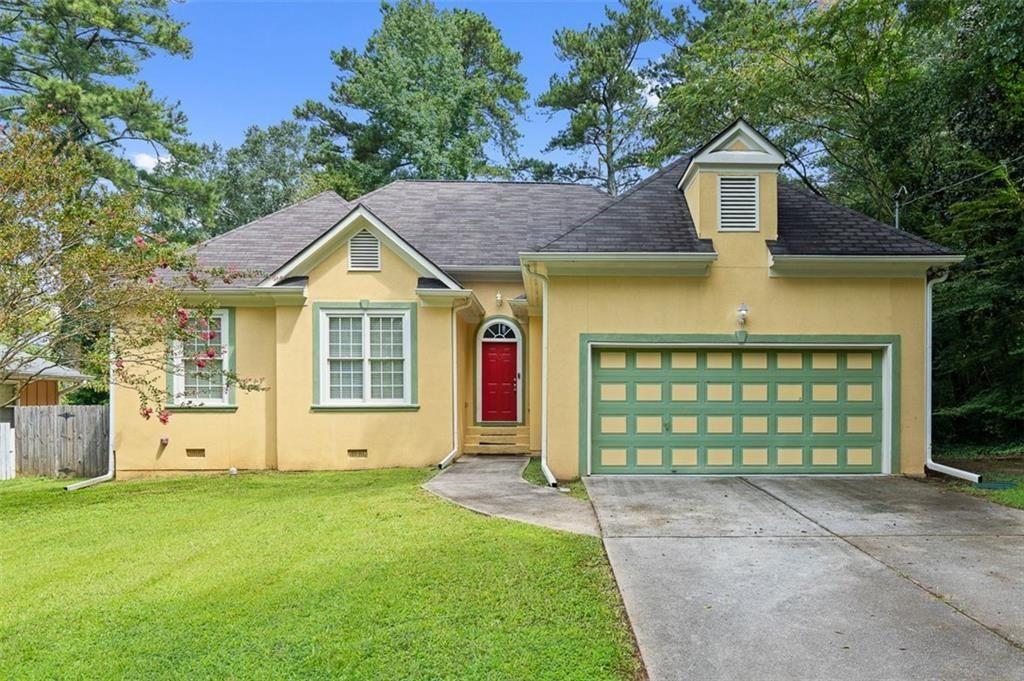 2313 Manor Avenue Atlanta, GA 30344 - Photo 1 of 31 a front view of a house with a garden
