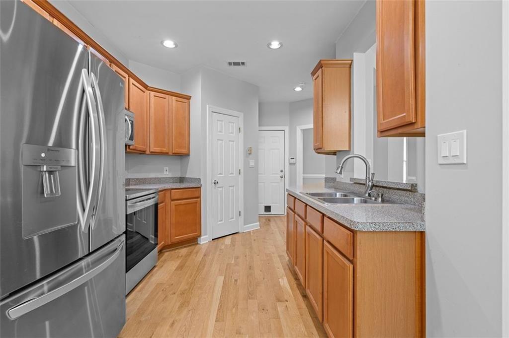 2313 Manor Avenue Atlanta, GA 30344 - Photo 11 of 31 a kitchen with stainless steel appliances granite countertop a sink stove and refrigerator