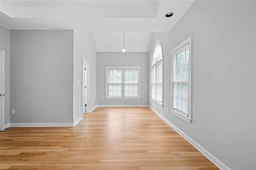 2313 Manor Avenue Atlanta, GA 30344 - Photo 21 of 31 a view of an empty room with wooden floor and a window