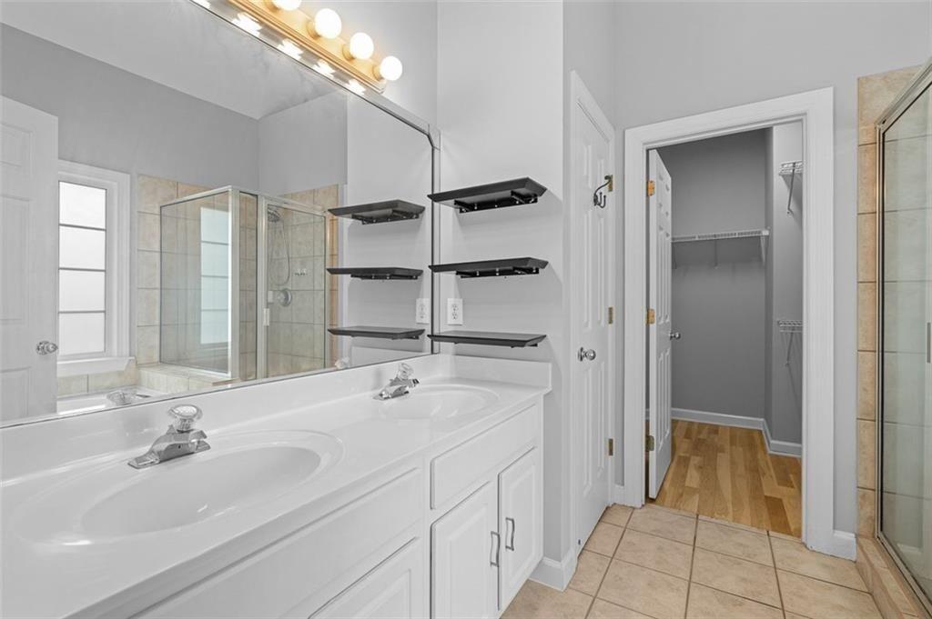 2313 Manor Avenue Atlanta, GA 30344 - Photo 23 of 31 a bathroom with a double vanity sink a vanity and a mirror