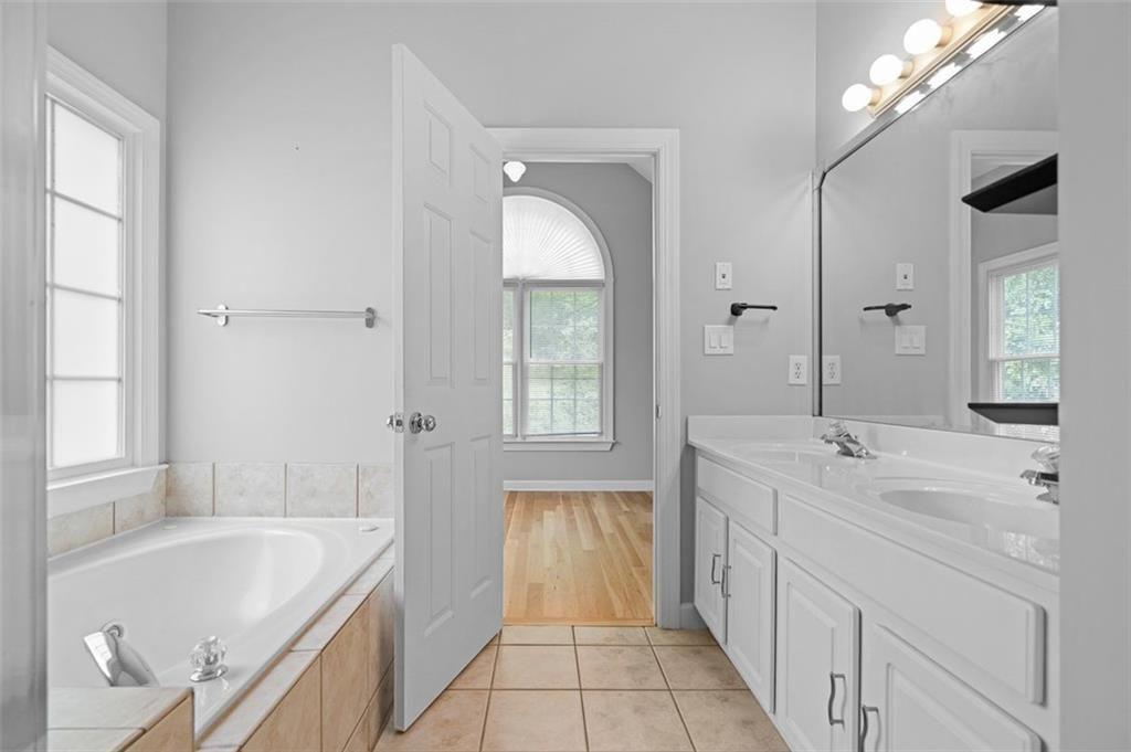 2313 Manor Avenue Atlanta, GA 30344 - Photo 26 of 31 a spacious bathroom with a tub sink and mirror