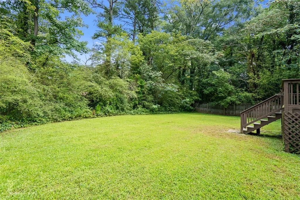 2313 Manor Avenue Atlanta, GA 30344 - Photo 29 of 31 a view of a large yard with a tree